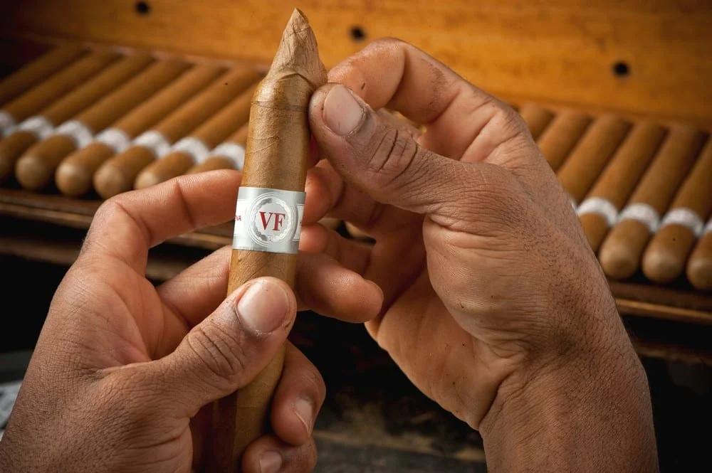 VEGAFINA - Classic Line Robusto, πούρο, δύο χέρια που τυλίγουν ένα πούρο.